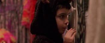 Movie still from “Trick 'r Treat” (2007), directed by Michael Dougherty – A young boy in a bear costume eating a snack; Close Up shot, Low angle