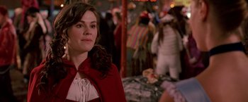 Movie still from “Trick 'r Treat” (2007), directed by Michael Dougherty – A woman in a red cape standing next to a crowd of onlookers; Close Up shot, Over the shoulder angle
