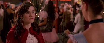 Movie still from “Trick 'r Treat” (2007), directed by Michael Dougherty – A woman in a red dress standing in front of a crowd; Close Up shot, Over the shoulder angle