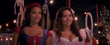 Movie still from “Trick 'r Treat” (2007), directed by Michael Dougherty – Two beautiful women posing for a picture at a carnival; Medium shot, High angle