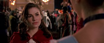 Movie still from “Trick 'r Treat” (2007), directed by Michael Dougherty – A woman in a red coat standing next to a crowd of onlookers; Close Up shot, Over the shoulder angle