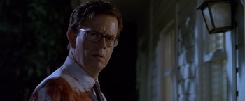 Movie still from “Trick 'r Treat” (2007), directed by Michael Dougherty – A person wearing glasses and a tie; Close Up shot, Low angle