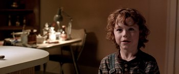 Movie still from “Trick 'r Treat” (2007), directed by Michael Dougherty – A little boy sitting in front of a desk; Close Up shot, Over the shoulder angle