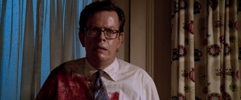Movie still from “Trick 'r Treat” (2007), directed by Michael Dougherty – A man in a white dress shirt and tie with blood all over his face; Close Up shot, Over the shoulder angle