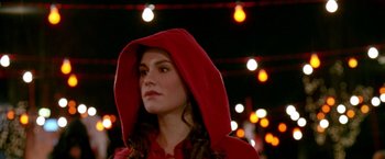 Movie still from “Trick 'r Treat” (2007), directed by Michael Dougherty – A woman wearing a red hooded jacket and looking to her left; Close Up shot, Over the shoulder angle