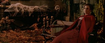 Movie still from “Trick 'r Treat” (2007), directed by Michael Dougherty – A basket sitting on top of a pile of leaves next to a tree; Medium shot, High angle