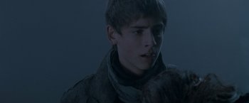 Movie still from “Trick 'r Treat” (2007), directed by Michael Dougherty – A young man in a dark room looking at the camera; Close Up shot, Over the shoulder angle