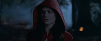 Movie still from “Trick 'r Treat” (2007), directed by Michael Dougherty – A woman wearing a red hooded jacket and a bow tie; Close Up shot, Over the shoulder angle