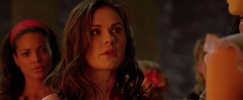 Movie still from “Trick 'r Treat” (2007), directed by Michael Dougherty – A person wearing a dress with blood all over her face; Close Up shot, Over the shoulder angle