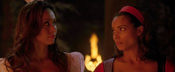 Movie still from “Trick 'r Treat” (2007), directed by Michael Dougherty – Two beautiful women standing next to each other in front of a fire; Close Up shot, Over the shoulder angle