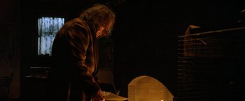 Movie still from “Trick 'r Treat” (2007), directed by Michael Dougherty – A man standing in front of a fire pit; Medium shot, Low angle