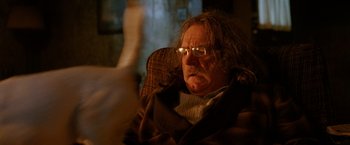 Movie still from “Trick 'r Treat” (2007), directed by Michael Dougherty – An older man sitting in a chair with glasses on; Close Up shot, Low angle