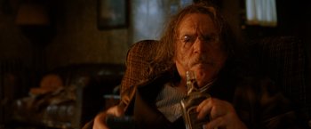 Movie still from “Trick 'r Treat” (2007), directed by Michael Dougherty – An old man with a long beard is sitting in a chair; Close Up shot, Over the shoulder angle