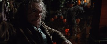 Movie still from “Trick 'r Treat” (2007), directed by Michael Dougherty – An older man with a beard and a jacket on; Close Up shot, Low angle