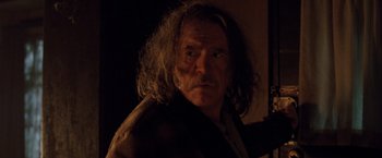 Movie still from “Trick 'r Treat” (2007), directed by Michael Dougherty – An older man with long hair and a beard; Close Up shot, Over the shoulder angle