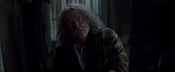 Movie still from “Trick 'r Treat” (2007), directed by Michael Dougherty – An older man with long white hair stares at the camera; Close Up shot, Low angle