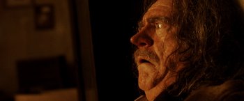Movie still from “Trick 'r Treat” (2007), directed by Michael Dougherty – An older man with a beard and mustache looking up; Close Up shot, Low angle