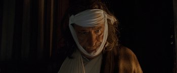 Movie still from “Trick 'r Treat” (2007), directed by Michael Dougherty – A man with a bandage on his head; Close Up shot, Low angle