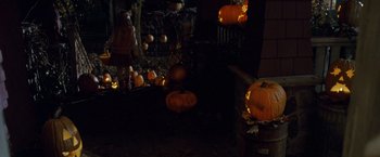 Movie still from “Trick 'r Treat” (2007), directed by Michael Dougherty – Many pumpkins that are lit up at night; Wide shot, High angle