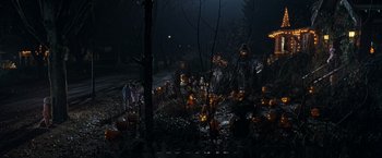 Movie still from “Trick 'r Treat” (2007), directed by Michael Dougherty – A group of people standing around a forest filled with pumpkins; Extreme Wide shot, High angle