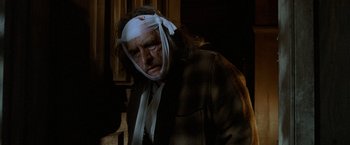 Movie still from “Trick 'r Treat” (2007), directed by Michael Dougherty – A man with bandages on his head and a bandage on his face; Close Up shot, Low angle