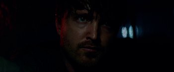 Movie still from “Triple 9” (2016), directed by John Hillcoat – A person's face in the dark; Close Up shot, Over the shoulder angle
