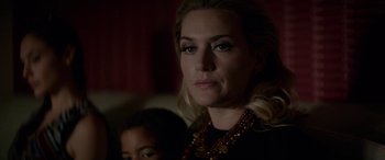 Movie still from “Triple 9” (2016), directed by John Hillcoat – A person wearing a necklace; Close Up shot, Over the shoulder angle