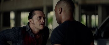 Movie still from “Triple 9” (2016), directed by John Hillcoat – A man looking at another man in the mirror; Close Up shot, Over the shoulder angle