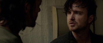 Movie still from “Triple 9” (2016), directed by John Hillcoat – A man in a black jacket talking to another man in a black jacket; Close Up shot, Over the shoulder angle