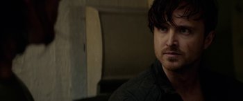 Movie still from “Triple 9” (2016), directed by John Hillcoat – A person wearing a black jacket; Close Up shot, Over the shoulder angle