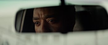 Movie still from “Triple 9” (2016), directed by John Hillcoat – A person's eyes looking out a window; Extreme Close Up shot, Over the shoulder angle