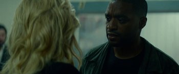 Movie still from “Triple 9” (2016), directed by John Hillcoat – A man and a woman are talking to each other; Close Up shot, Over the shoulder angle