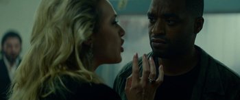 Movie still from “Triple 9” (2016), directed by John Hillcoat – A man and a woman looking at one another in the mirror; Close Up shot, Over the shoulder angle