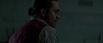 Movie still from “Triple 9” (2016), directed by John Hillcoat – A person wearing a jacket; Close Up shot, Over the shoulder angle