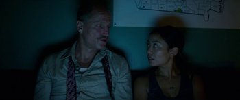 Movie still from “Triple 9” (2016), directed by John Hillcoat – A man and a woman sitting next to each other; Close Up shot, Low angle