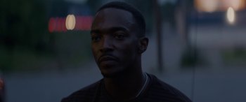 Movie still from “Triple 9” (2016), directed by John Hillcoat – A person wearing a black shirt; Close Up shot, High angle