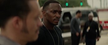 Movie still from “Triple 9” (2016), directed by John Hillcoat – A person wearing a black shirt; Close Up shot, Over the shoulder angle