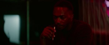 Movie still from “Triple 9” (2016), directed by John Hillcoat – A man is holding a pencil in his hand; Close Up shot, High angle
