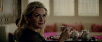 Movie still from “Triple 9” (2016), directed by John Hillcoat – A beautiful woman holding a glass of wine in her hand; Close Up shot, Over the shoulder angle