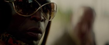Movie still from “Triple 9” (2016), directed by John Hillcoat – A person wearing glasses; Extreme Close Up shot, Low angle