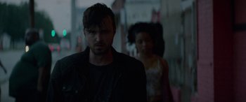 Movie still from “Triple 9” (2016), directed by John Hillcoat – A man and a woman are standing in a dark room; Close Up shot, Low angle