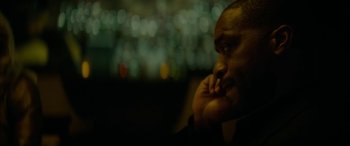 Movie still from “Triple 9” (2016), directed by John Hillcoat – A person with his hand to his face; Close Up shot, Over the shoulder angle