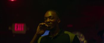 Movie still from “Triple 9” (2016), directed by John Hillcoat – A man is holding a tooth brush in his mouth; Close Up shot, Low angle