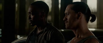 Movie still from “Triple 9” (2016), directed by John Hillcoat – Two men standing next to each other in the dark; Close Up shot, Over the shoulder angle