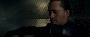 Movie still from “Triple 9” (2016), directed by John Hillcoat – A person wearing headphones; Close Up shot, Low angle