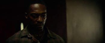 Movie still from “Triple 9” (2016), directed by John Hillcoat – A person wearing a shirt; Close Up shot, High angle