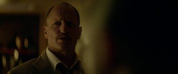 Movie still from “Triple 9” (2016), directed by John Hillcoat – A man in a white dress shirt and a tie; Close Up shot, Low angle