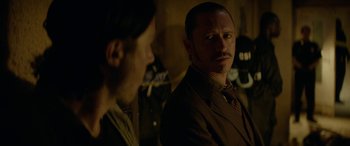 Movie still from “Triple 9” (2016), directed by John Hillcoat – A man and a woman are looking at each other; Close Up shot, Over the shoulder angle