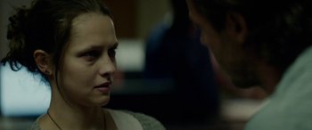 Movie still from “Triple 9” (2016), directed by John Hillcoat – Two people talking to each other in a dark room; Close Up shot, Over the shoulder angle