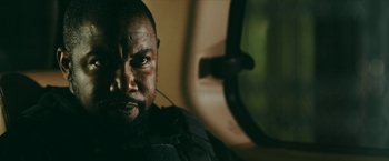 Movie still from “Triple Threat” (2019), directed by Jesse V. Johnson – A person in a vehicle; Close Up shot, Over the shoulder angle